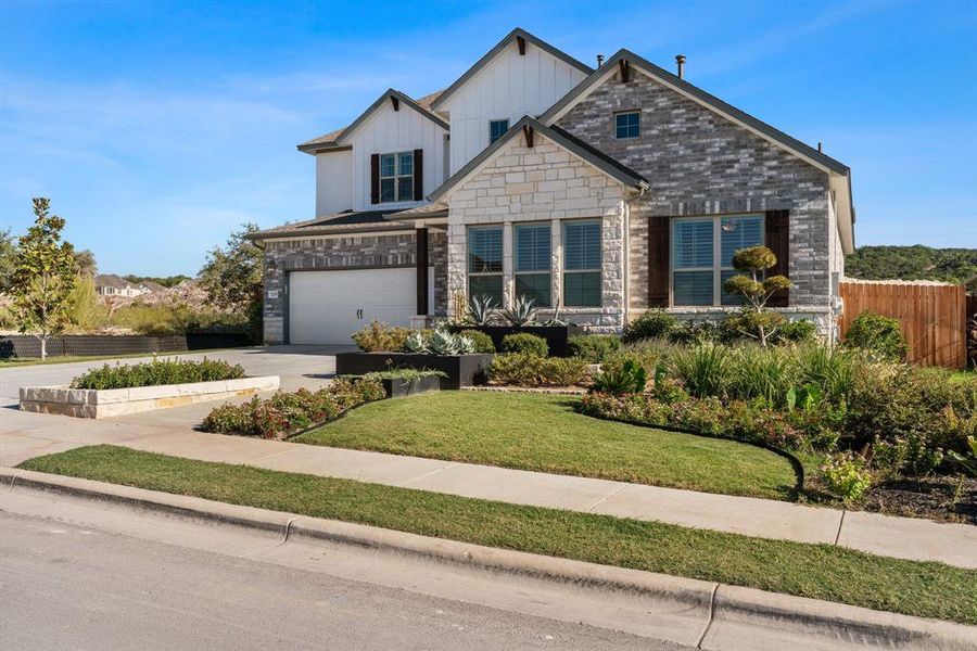 Gorgeous flower beds with xeriscape features and a look at the pristine exterior.