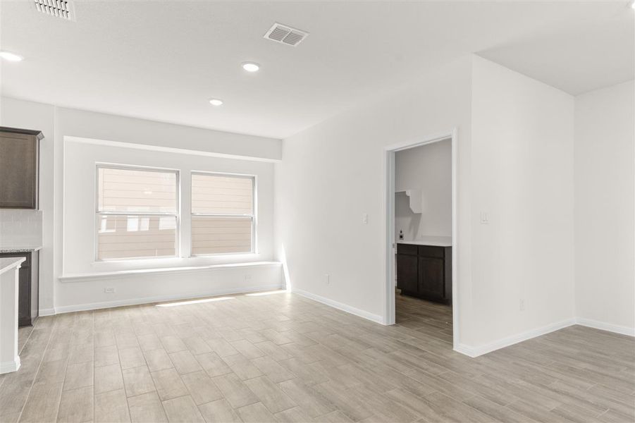 Unfurnished living room with recessed lighting, baseboards, light wood finished floors, and visible vents