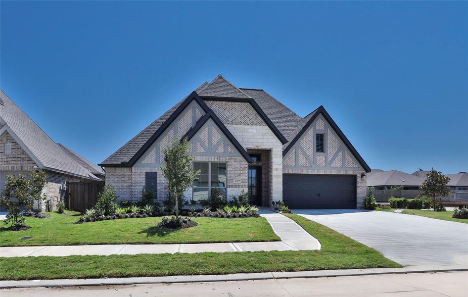Front exterior of a new home in Riceland 60', Mont Belvieu, TX, highlighting curb appeal (Image 13). Front exterior of a new home in Riceland 60', Mont Belvieu, TX, highlighting curb appeal (Image 13).