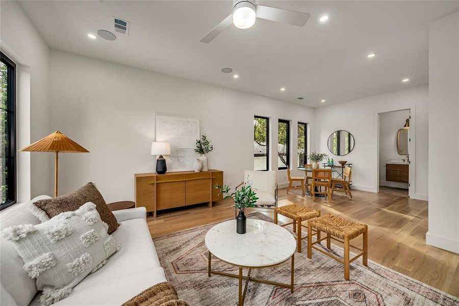 Living area featuring recessed lighting, wood finished floors, and ceiling fan Living area featuring recessed lighting, wood finished floors, and ceiling fan