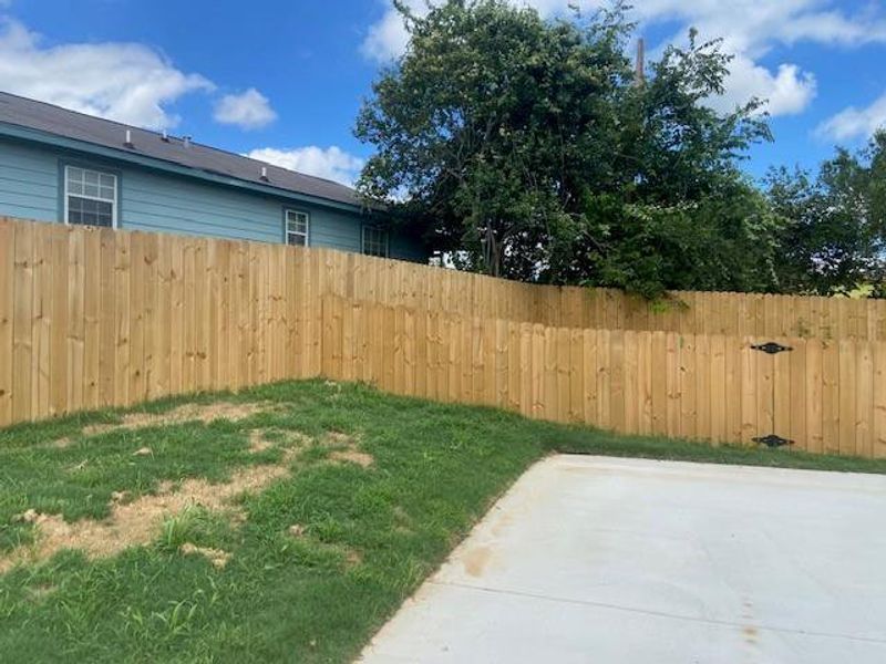 A well-maintained wooden privacy fence encloses a green yard, offering seclusion for outdoor living. A well-maintained wooden privacy fence encloses a green yard, offering seclusion for outdoor living.