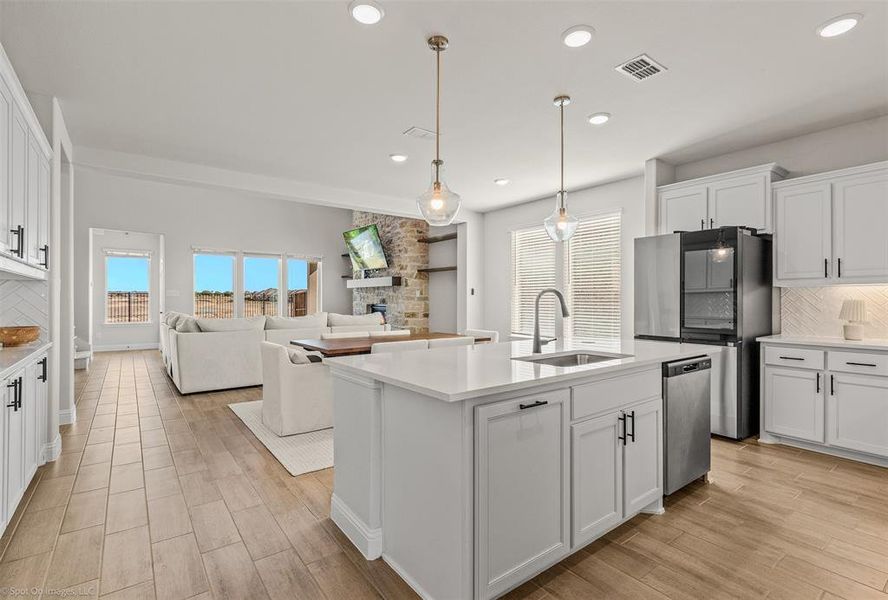 Spacious kitchen leading to open living area and take a look at that view!