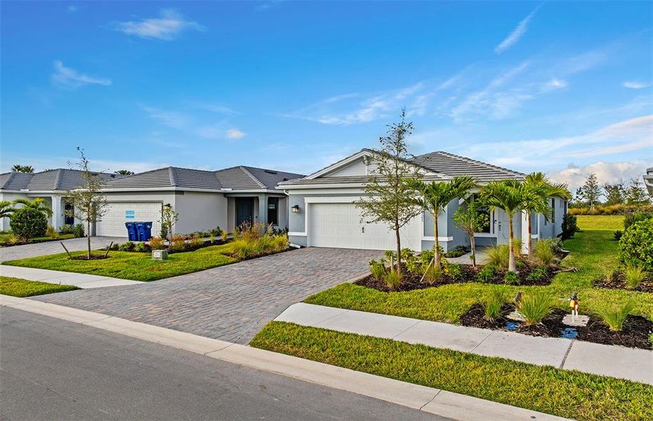 Front exterior of a new home in Del Webb Catalina, Lakewood Ranch, FL, highlighting curb appeal (Image 1). Front exterior of a new home in Del Webb Catalina, Lakewood Ranch, FL, highlighting curb appeal (Image 1).