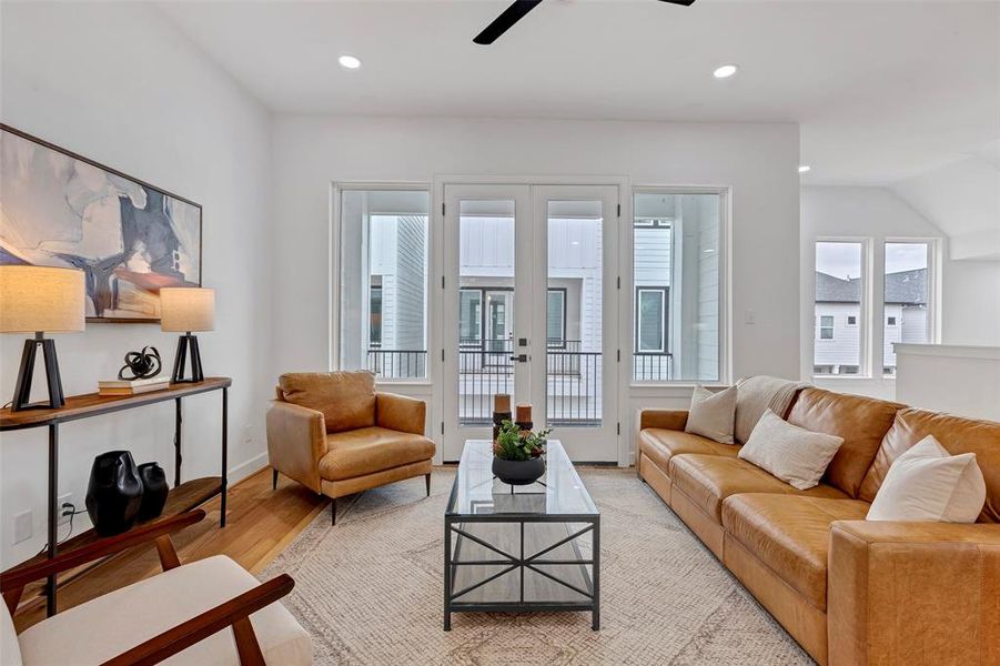 You'll love the bright and airy second-floor living area that flows directly into the covered patio, extending your living space. (Model Unit 9424C)