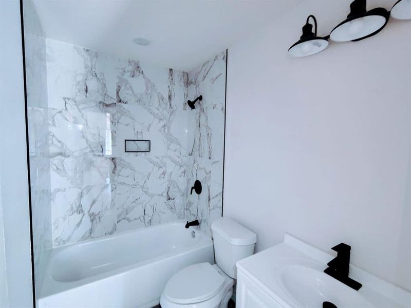 Bathroom featuring washtub / shower combination and vanity
