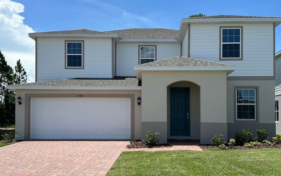 Front exterior of a new home in Trinity Place, St. Cloud, FL, highlighting curb appeal (Image 1). Front exterior of a new home in Trinity Place, St. Cloud, FL, highlighting curb appeal (Image 1).