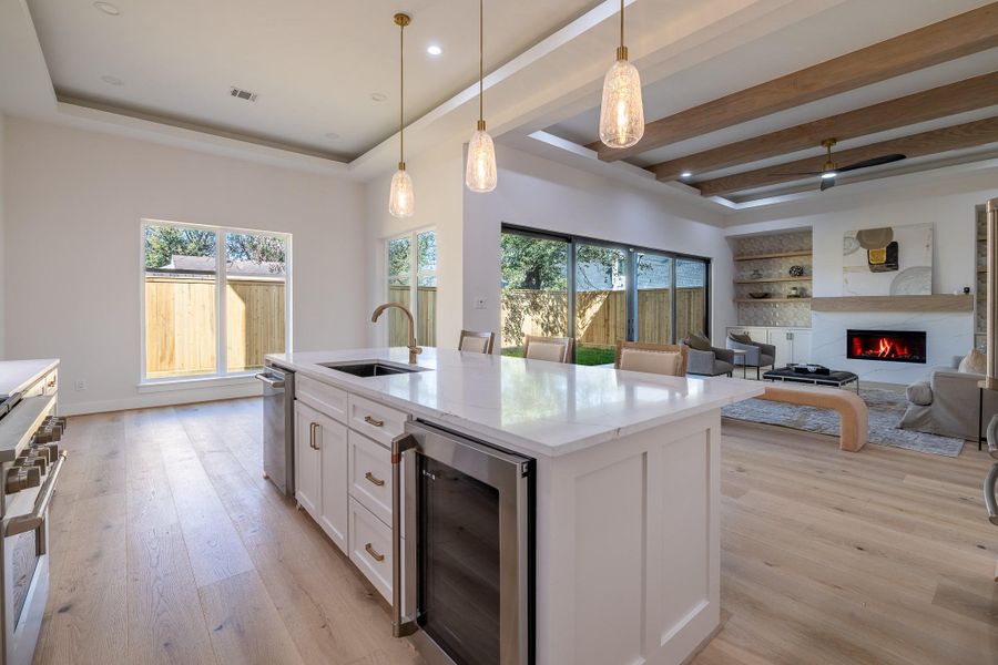 Seamless kitchen-to-living layout anchored by a statement island, ideal for gatherings and everyday living.