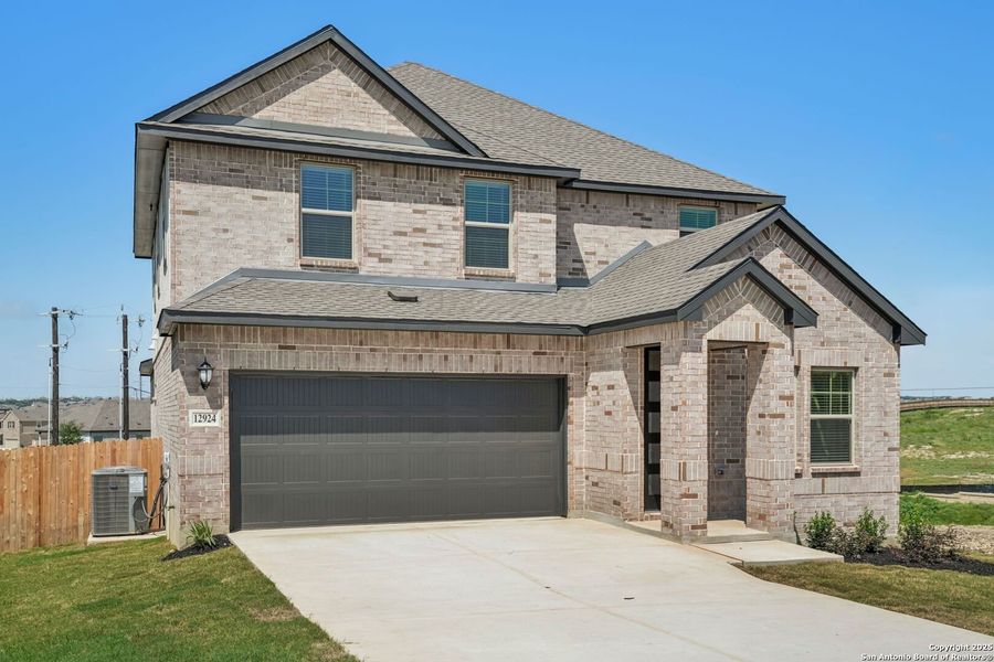 Front exterior of a new home in Arcadia Ridge - Premier Series, San Antonio, TX, highlighting curb appeal (Image 21). Front exterior of a new home in Arcadia Ridge - Premier Series, San Antonio, TX, highlighting curb appeal (Image 21).