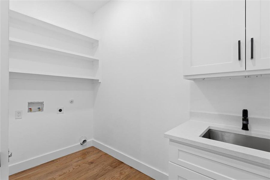 Laundry area featuring light wood-type flooring, washer hookup, hookup for a gas dryer, and electric dryer hookup