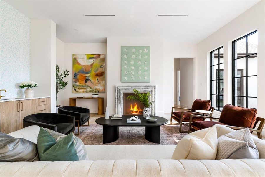 Living area with a lit fireplace Living area with a lit fireplace