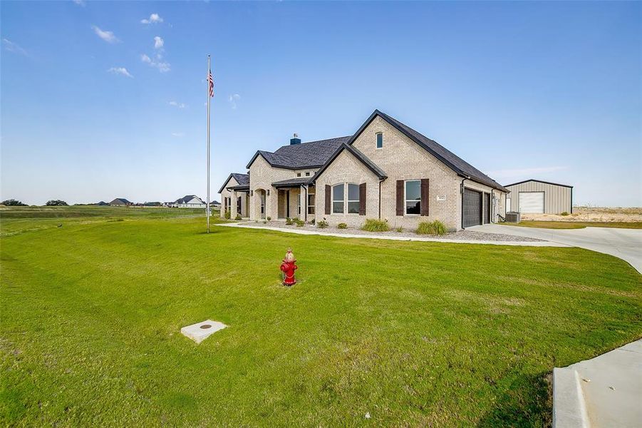 Front exterior of a new home in Rocky Top Ranch, Reno, TX, highlighting curb appeal (Image 1). Front exterior of a new home in Rocky Top Ranch, Reno, TX, highlighting curb appeal (Image 1).