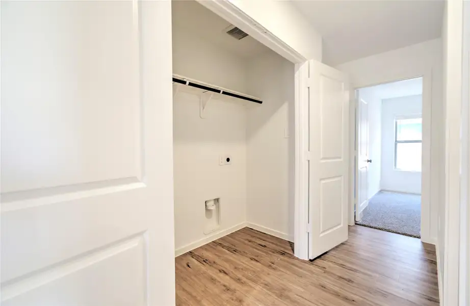 The utility area is conveniently located in the hallway to secondary bedrooms and bath.