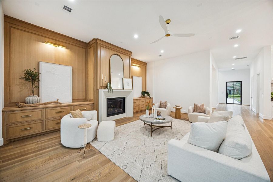 Warm white oak millwork anchors the living room with a custom built-in surround and clean fireplace detail. The home’s high-efficiency Trane HVAC system, spray foam envelope, and insulated flue ensure comfort year-round.