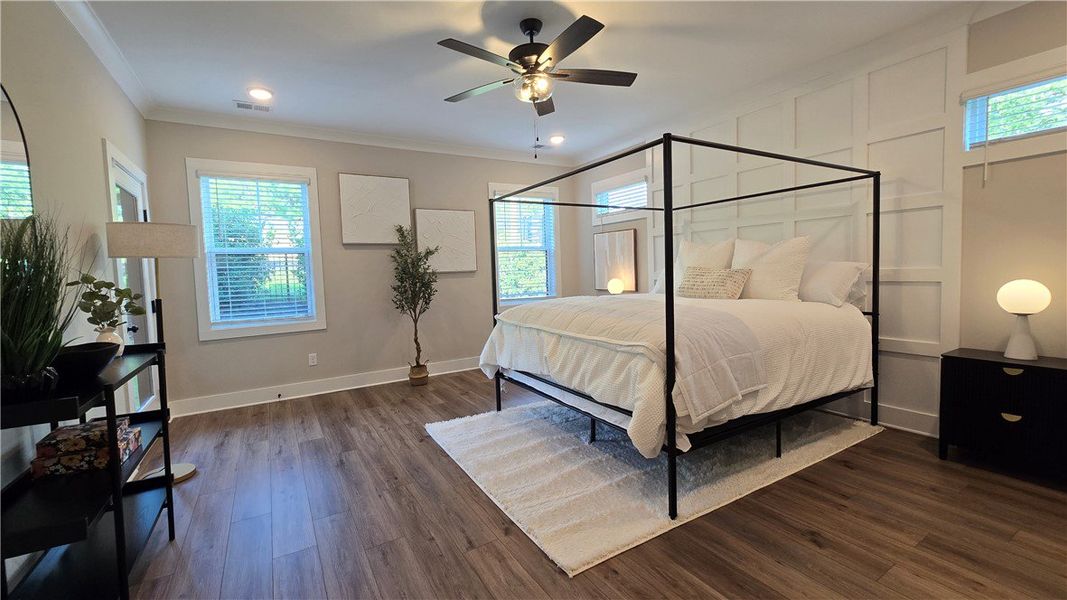 A tranquil primary bedroom suite featuring warm wo A tranquil primary bedroom suite featuring warm wo