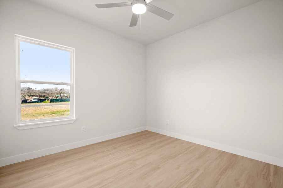 Unfurnished room with light wood-style flooring and a ceiling fan
