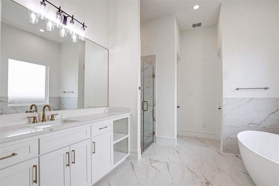 Bathroom with vanity, tile patterned flooring, and separate shower and tub