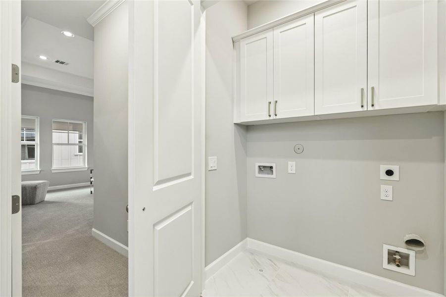Laundry closet with custom built-ins on the third floor.