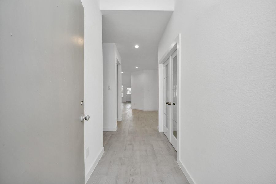 As you step into the threshold of this luxurious home, you'll soon be welcomed by an elegant glass door (to be installed). Inside, soaring ceilings amplify the spaciousness, while the refined wood-look tile flooring and oversized baseboards exude sophistication and charm. Sample photo of completed home with similar floor plan. Actual colors and selections may vary.