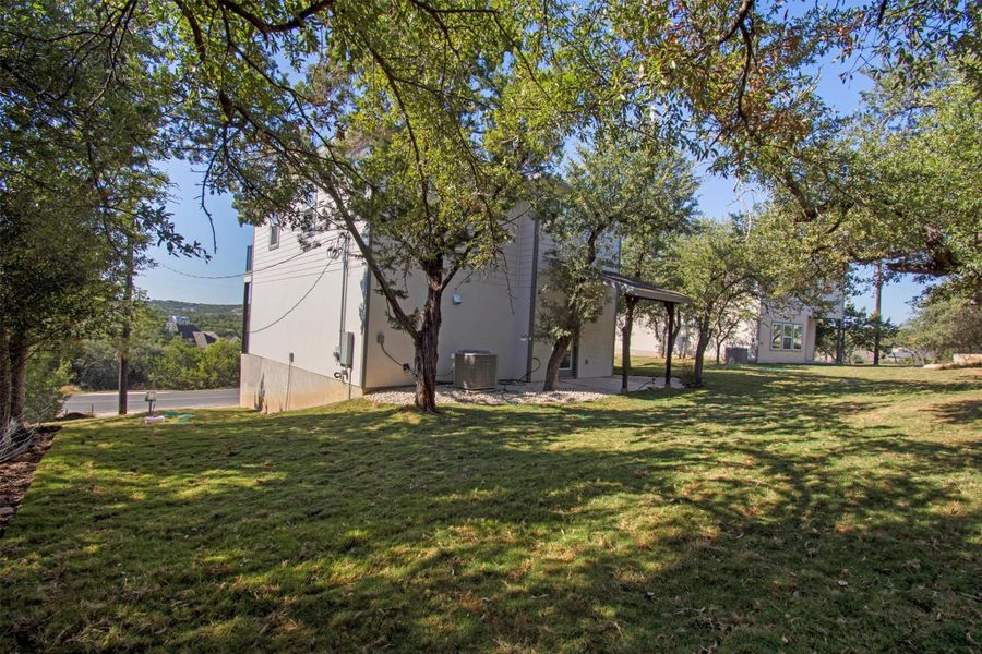 View of grassy yard featuring a patio area