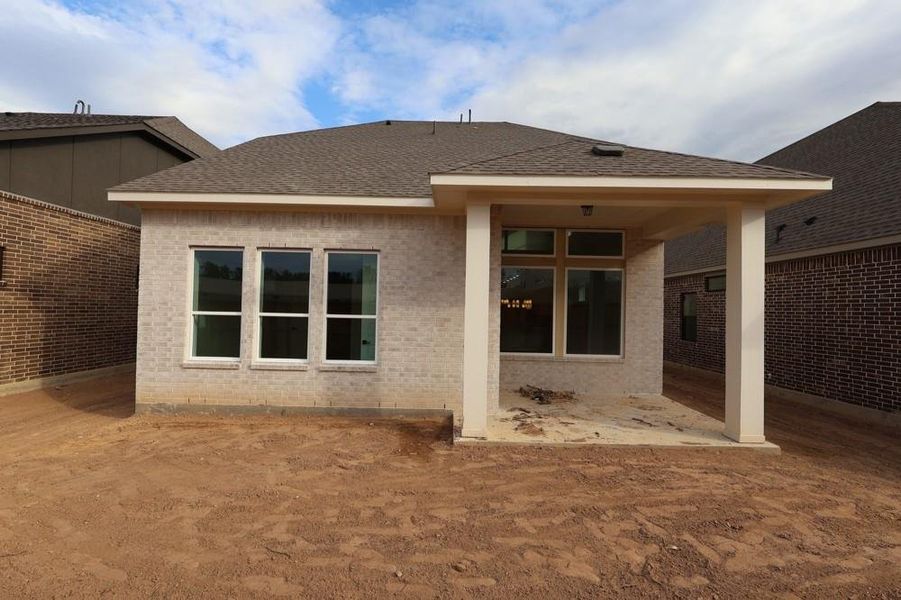 Front exterior of a new home in The Highlands 40', Porter, TX, highlighting curb appeal (Image 22). Front exterior of a new home in The Highlands 40', Porter, TX, highlighting curb appeal (Image 22).