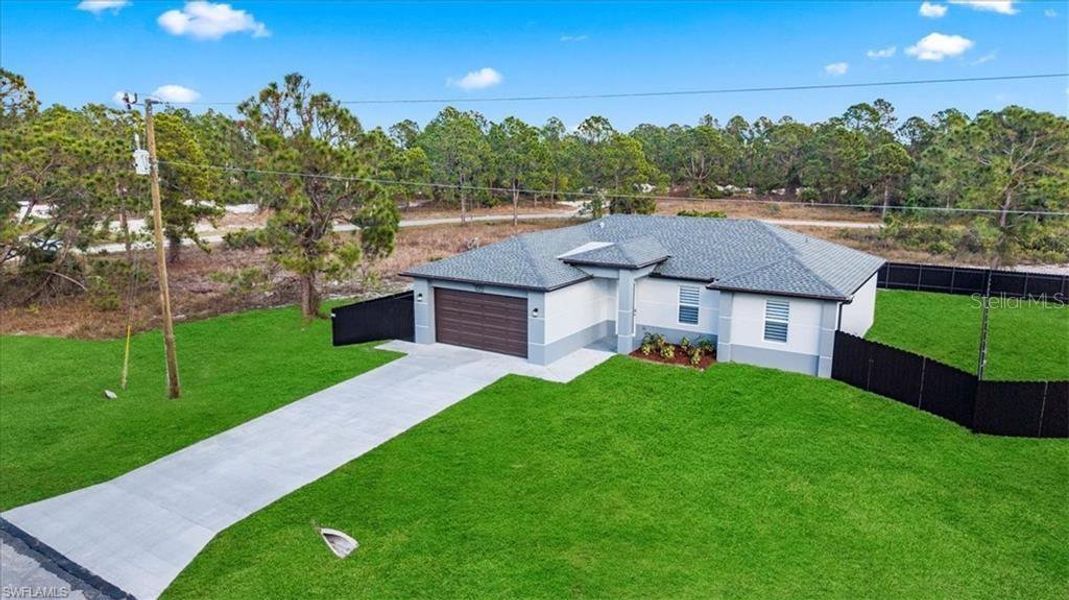 Front exterior of a new home in , Lehigh Acres, FL, highlighting curb appeal (Image 22).