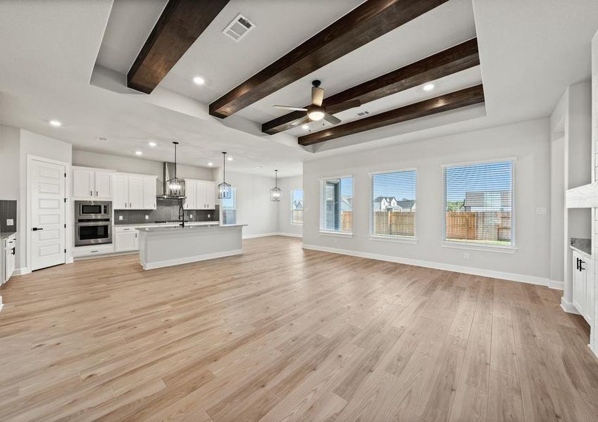 Spacious open floor plan with beams on the ceiling.