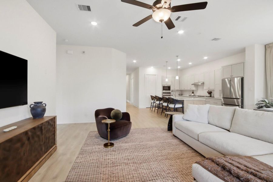 Spacious open-concept living area with a modern kitchen, cozy seating, and sleek finishes.