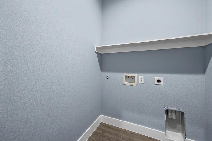 Laundry room featuring dark wood-type flooring, hookup for a washing machine, gas dryer hookup, and hookup for an electric dryer