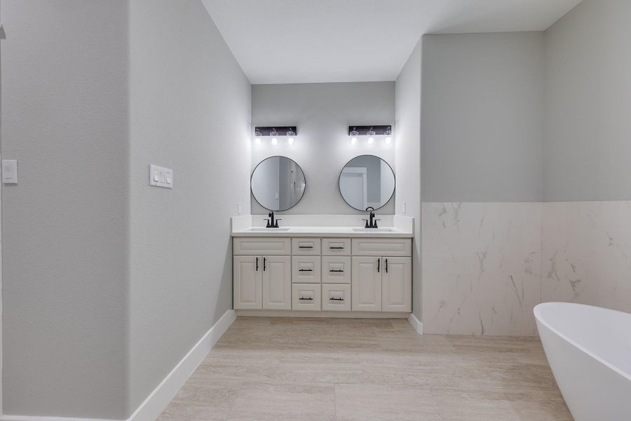 Primary bath featuring double sinks, offering ample space for two and adding convenience to your daily routine. Primary bath featuring double sinks, offering ample space for two and adding convenience to your daily routine.