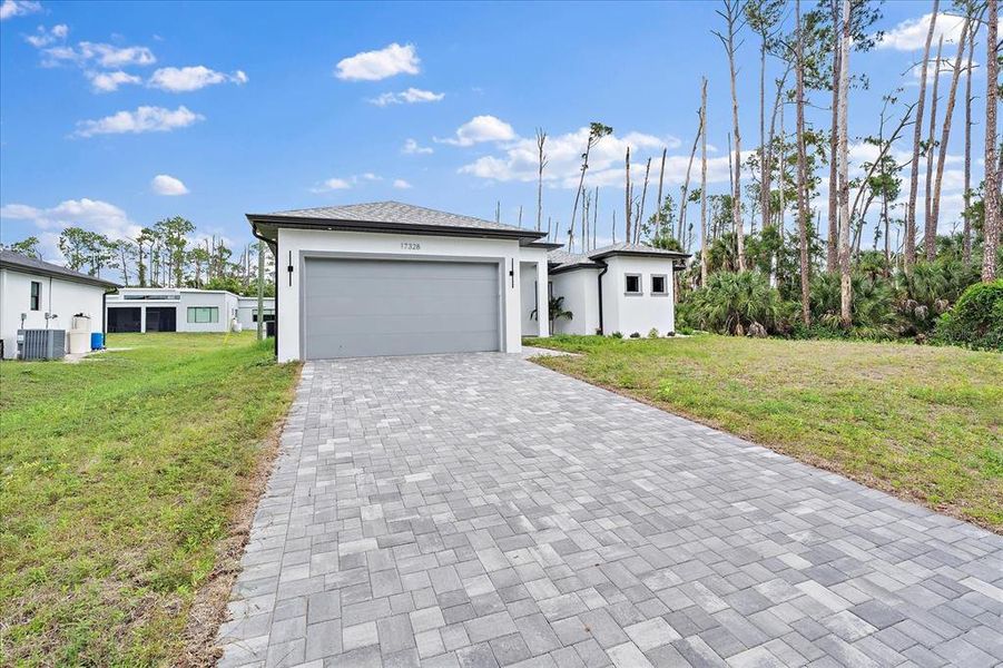 Front exterior of a new home in , Port Charlotte, FL, highlighting curb appeal (Image 17).
