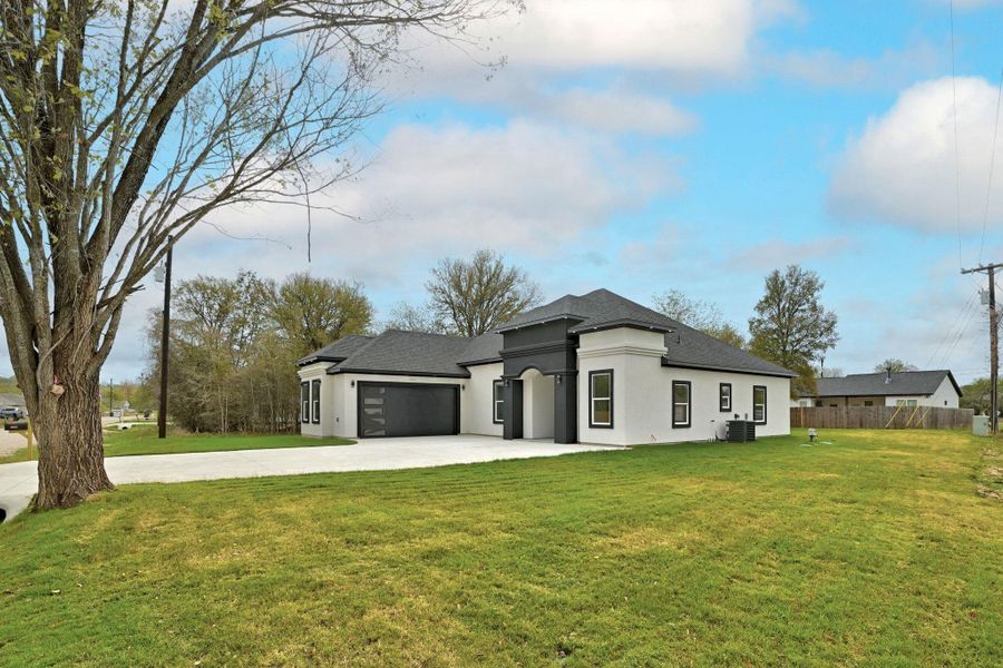 Front exterior of a new home in , Bastrop, TX, highlighting curb appeal (Image 1).