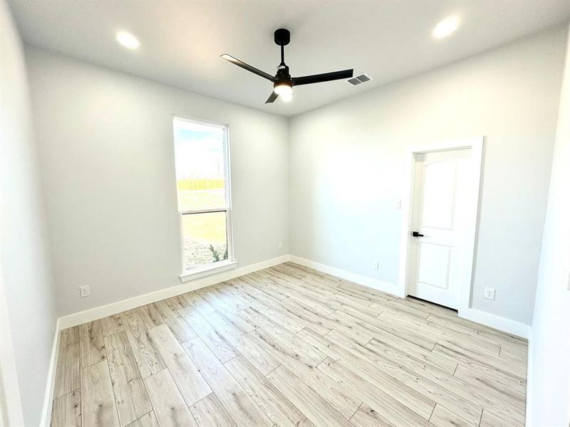 Spare room with ceiling fan and light wood-type flooring