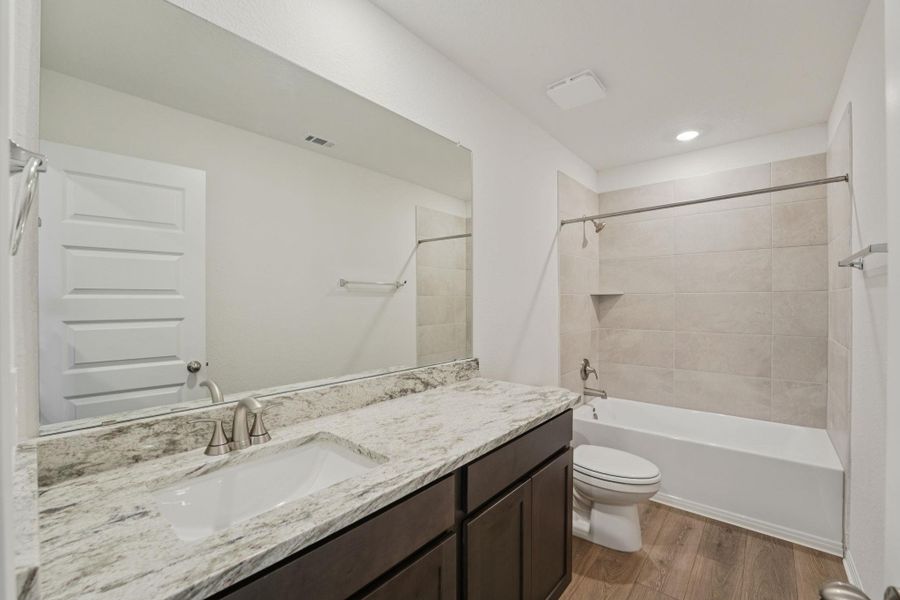 Full bath with vanity, tub / shower combination, and dark wood finished floors