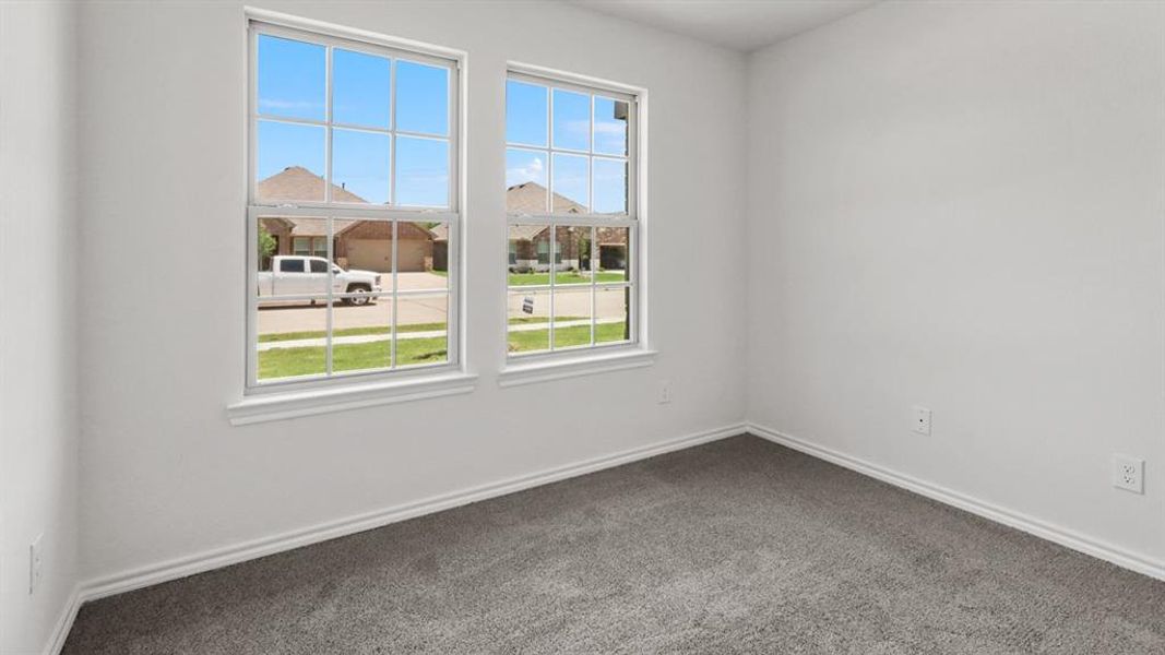 Room featuring two large windows with grid muntins, white trim, light gray carpeting, and white painted walls
