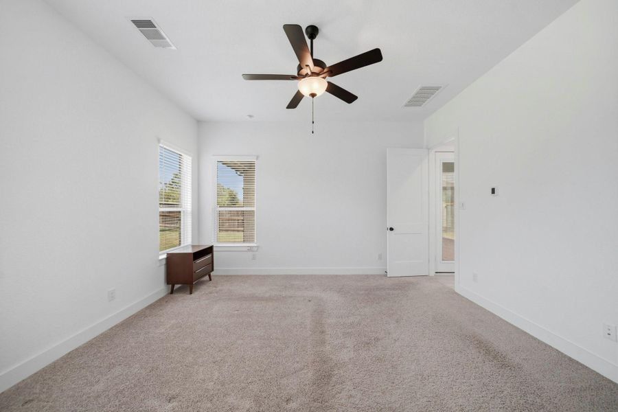 Come relax in the primary retreat with plush carpet, a ceiling fan, and direct access to your ensuite primary bathroom!