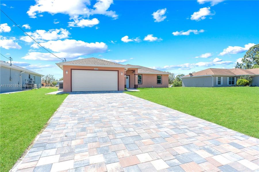 Front exterior of a new home in , Lehigh Acres, FL, highlighting curb appeal (Image 14).