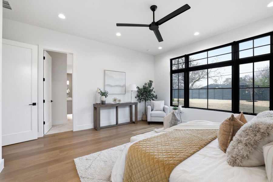 Bedroom featuring light wood-style flooring, recessed lighting, a ceiling fan, and ensuite bath