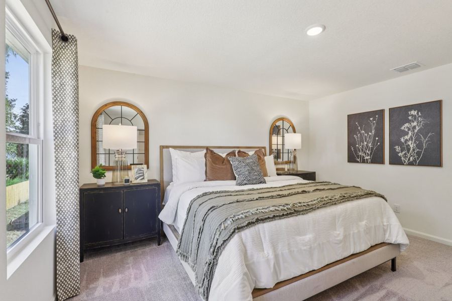 A bedroom with a large mirror. A bedroom with a large mirror.