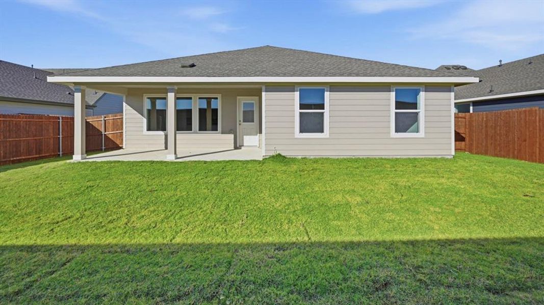 Back of property with a patio, a shingled roof, and a fenced backyard Back of property with a patio, a shingled roof, and a fenced backyard