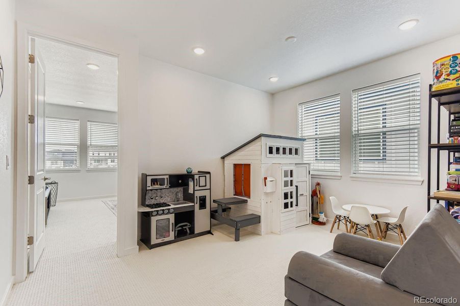 The second-level bonus room provides versatile space perfect for a home office, reading nook, toy room, or creative flex space.