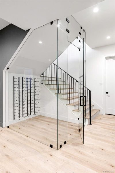 Lower level offers rec area, wine storage, gym, wet bar, powder room + bedroom with en suite private bath