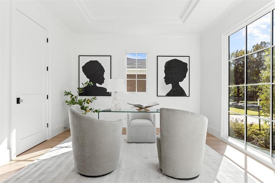 Office featuring wood finished floors and a raised ceiling Office featuring wood finished floors and a raised ceiling