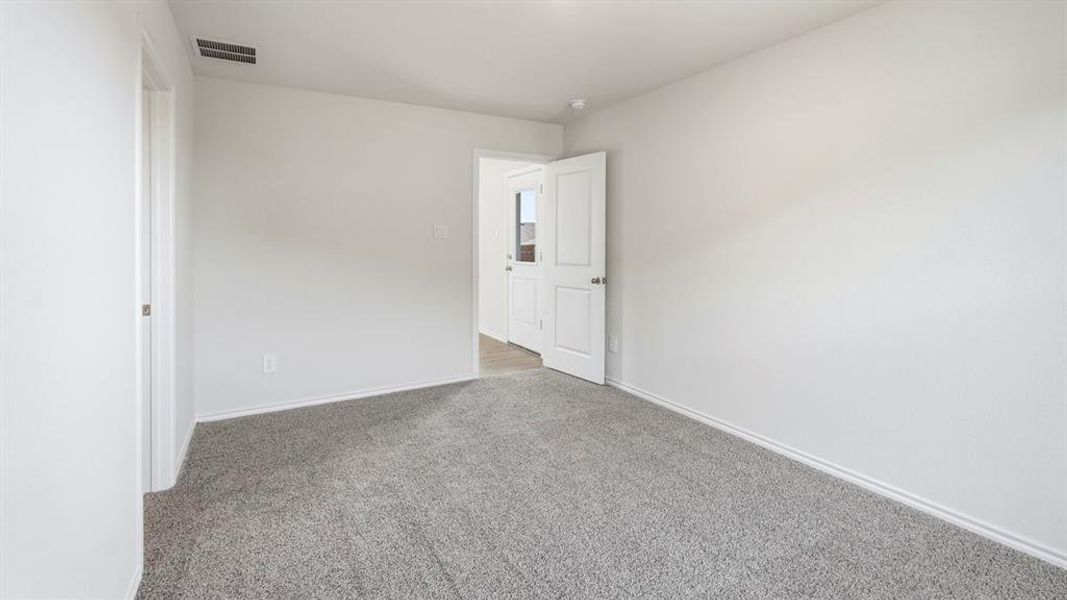 Unfurnished bedroom with carpet floors and baseboards Unfurnished bedroom with carpet floors and baseboards