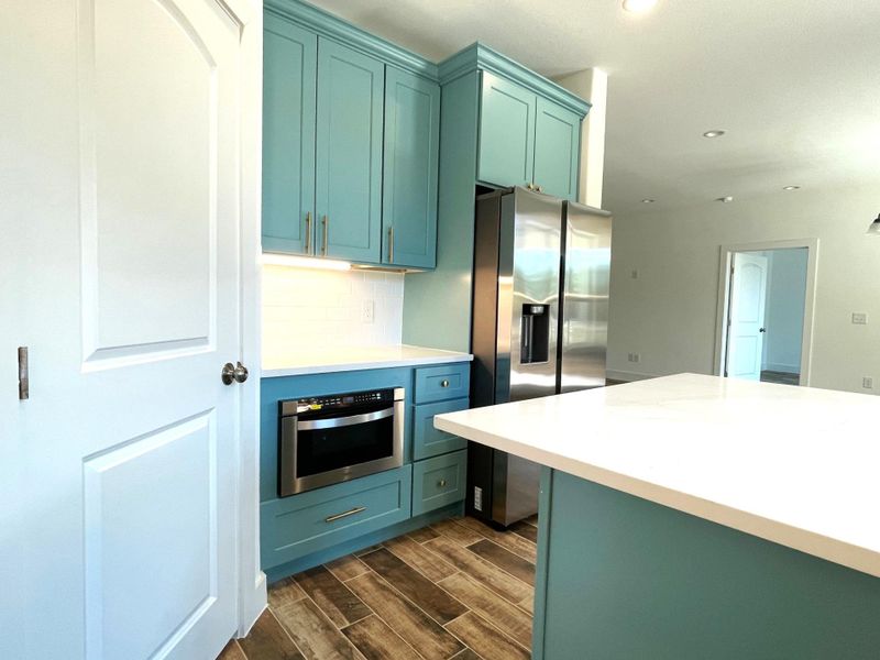 Kitchen with built-in microwave and plenty of cabinets
