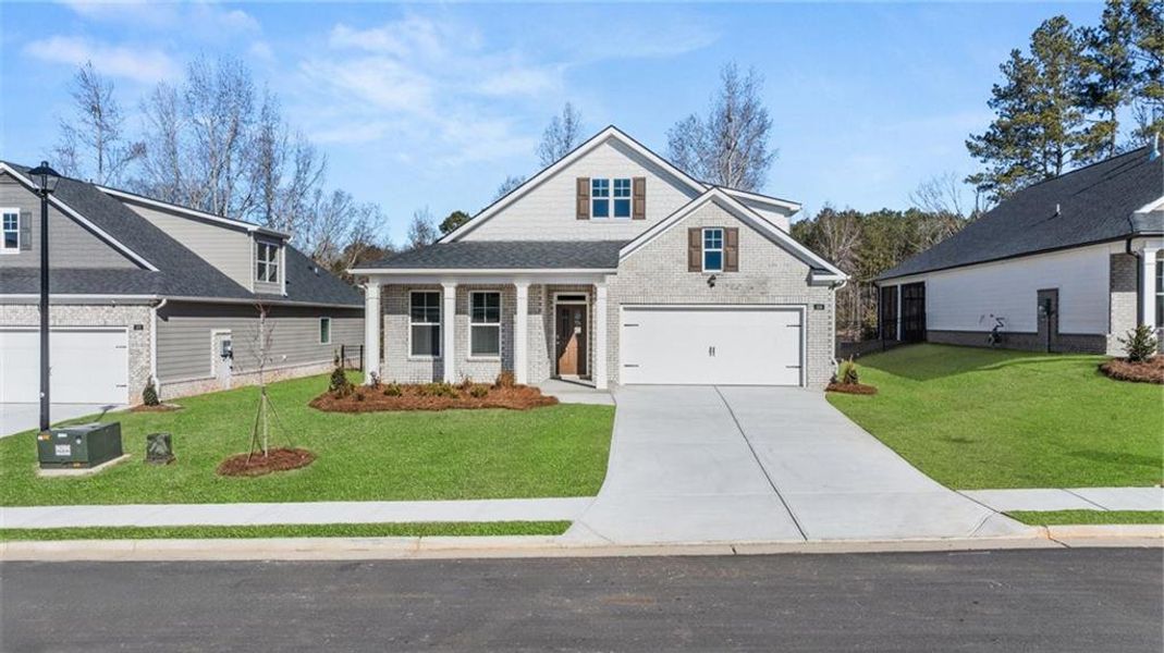 Front exterior of a new home in Oak Ridge Meadows - Active Adult, Locust Grove, GA, highlighting curb appeal (Image 1). Front exterior of a new home in Oak Ridge Meadows - Active Adult, Locust Grove, GA, highlighting curb appeal (Image 1).