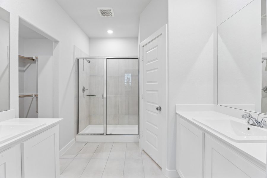 Primary Bathroom in the Cedar home plan by Trophy Signature Homes – REPRESENTATIVE PHOTO
