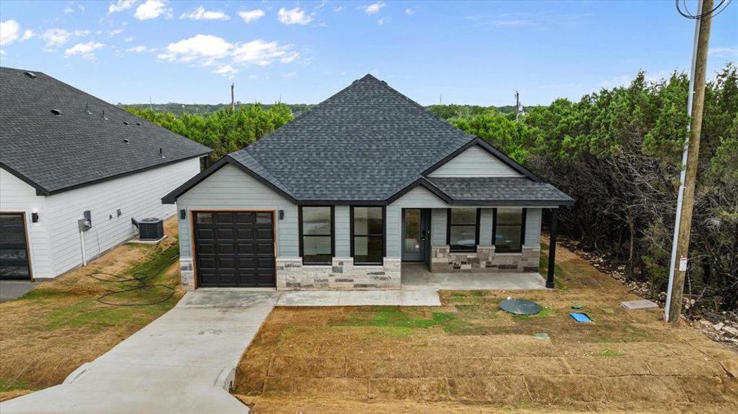 Front exterior of a new home in , Granbury, TX, highlighting curb appeal (Image 17).