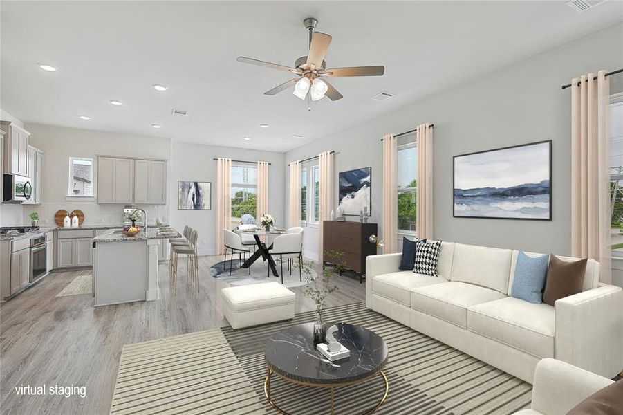 Living room with ceiling fan and light wood-type flooring