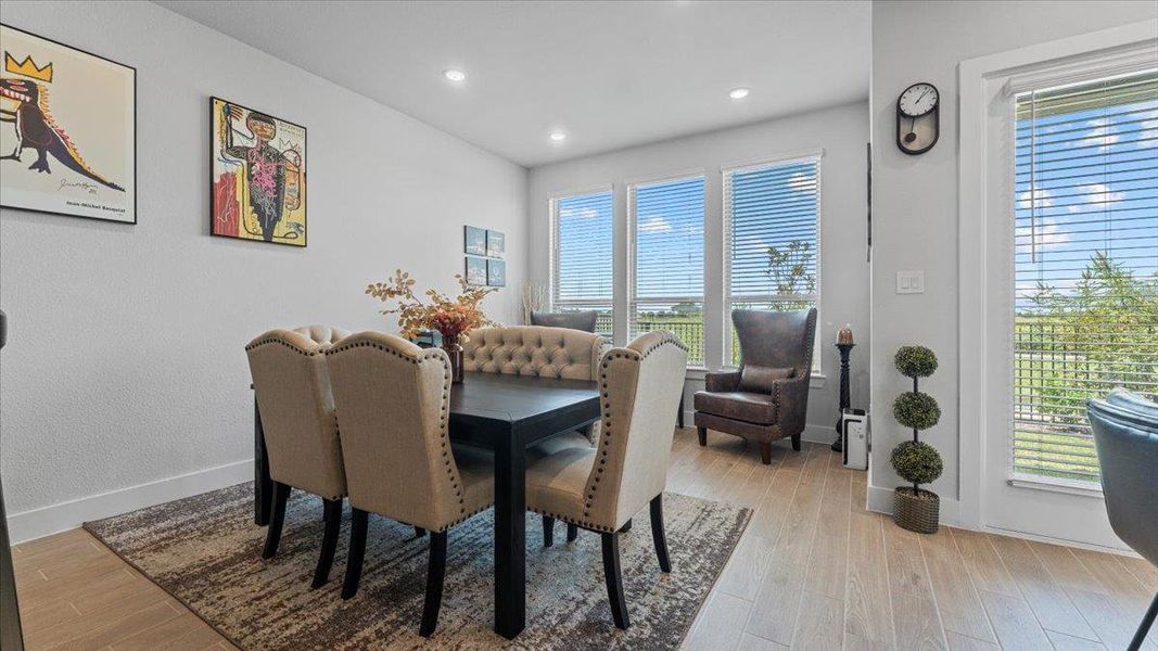 Dining area featuring light wood-style floors and recessed lighting Dining area featuring light wood-style floors and recessed lighting