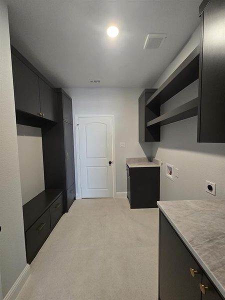 Washroom featuring cabinet space, hookup for a washing machine, and electric dryer hookup